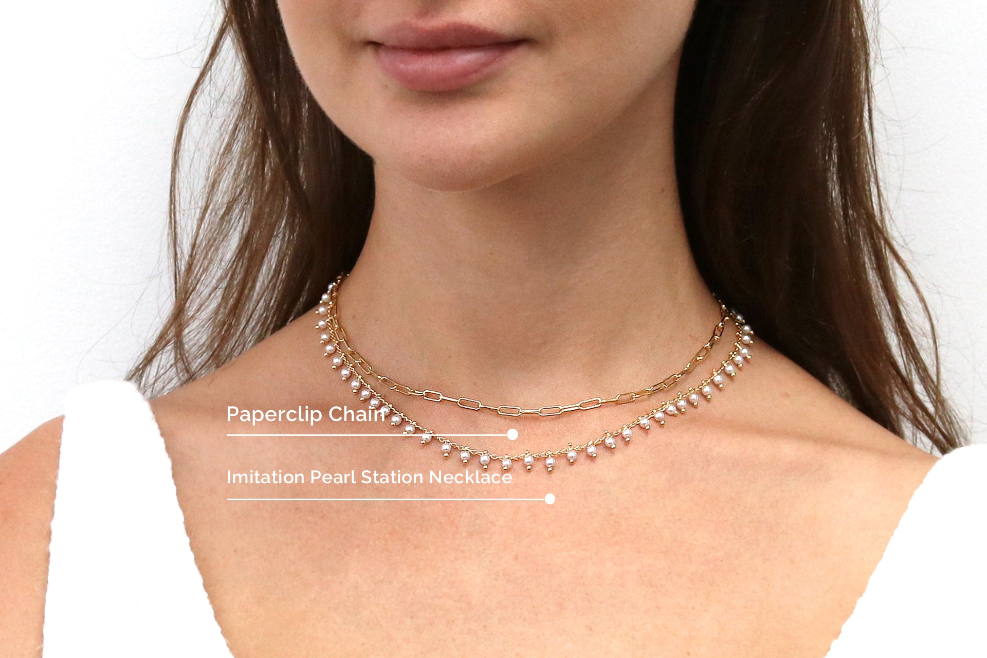 Model wearing layered chain necklaces