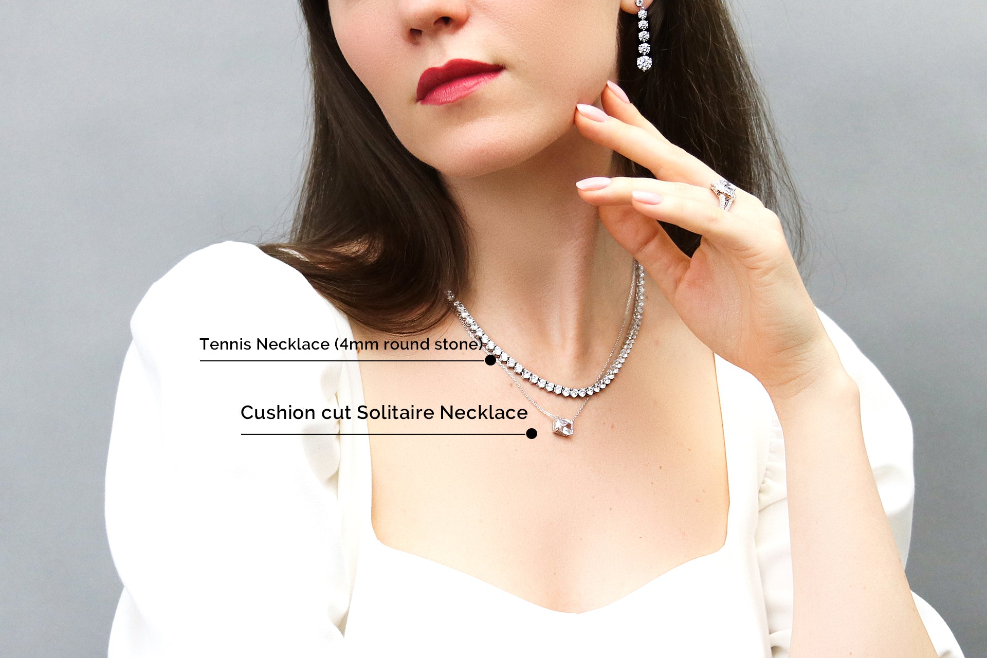 Model wearing tennis necklace layered with a solitaire necklace