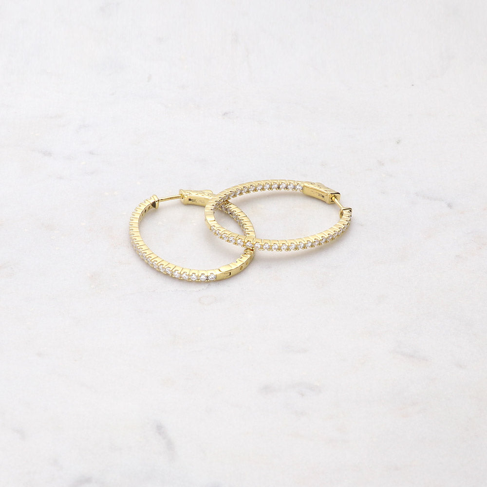 Flatlay view of Oval CZ Inside-Out Hoop Earrings in Sterling Silver 1.4 inch, Yellow Gold Flashed