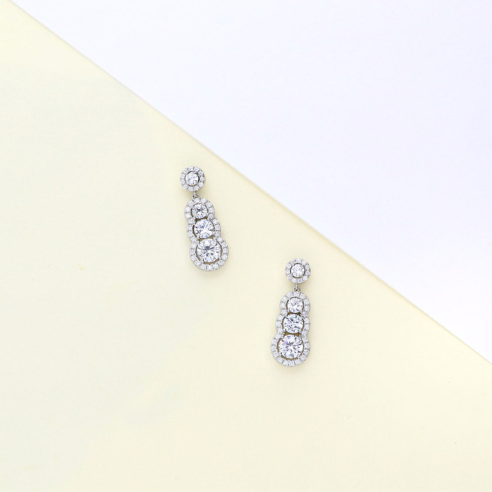 Flatlay view of Graduated Halo CZ Dangle Earrings in Sterling Silver, 5 of 6