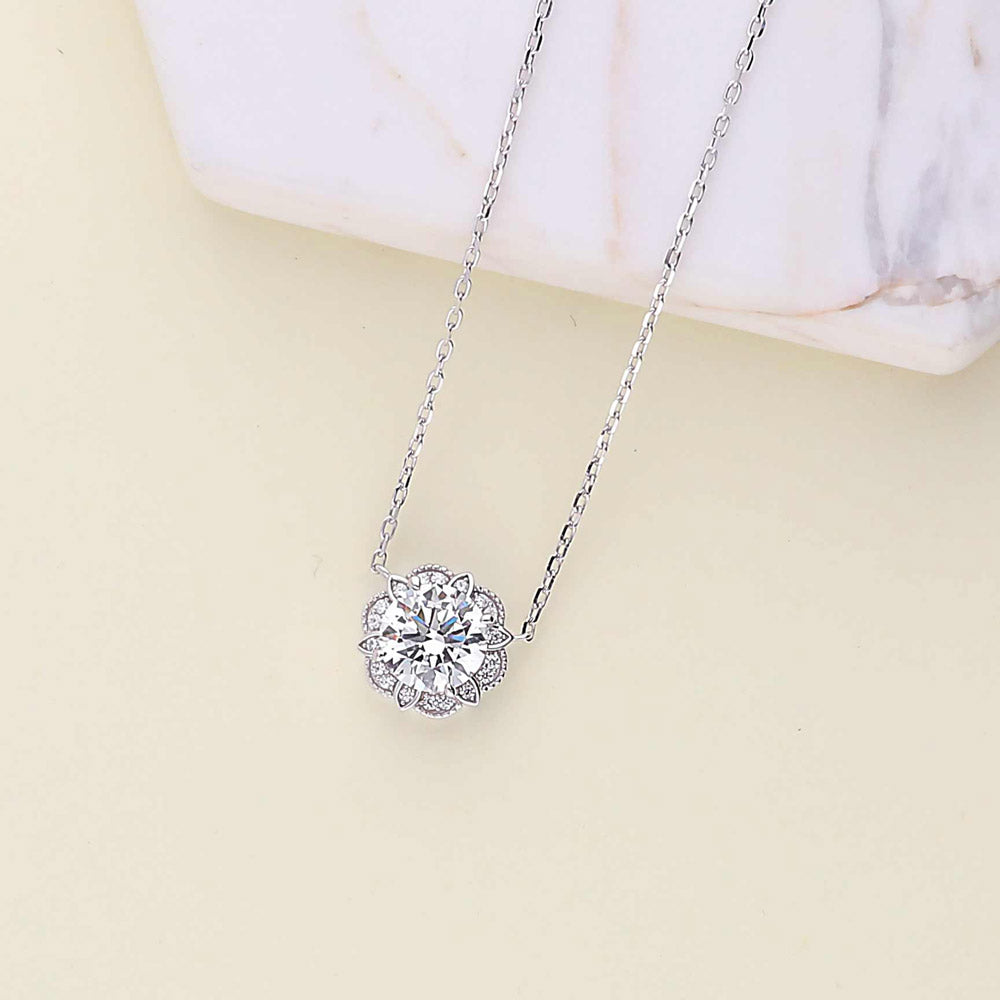 Flatlay view of Flower Halo CZ Necklace and Earrings Set in Sterling Silver, 3 of 9