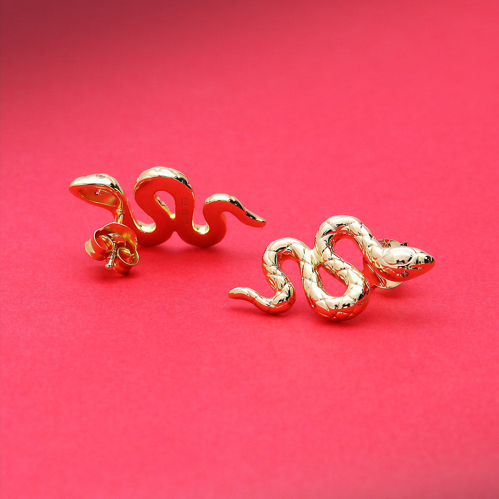 Flatlay view of Snake CZ Necklace and Earrings in Sterling Silver, Yellow Gold Flashed