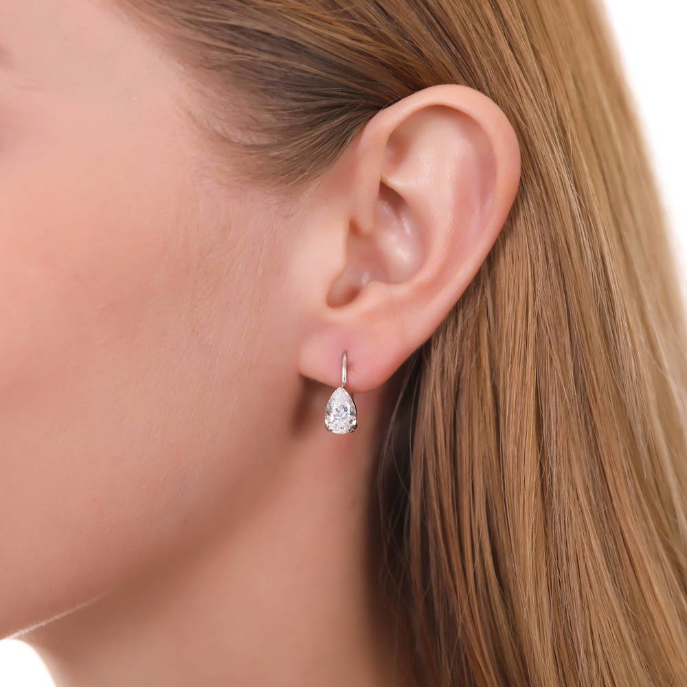 Model wearing Solitaire 1.6-2.6ct Pear CZ Leverback Earrings in Sterling Silver, Clear
