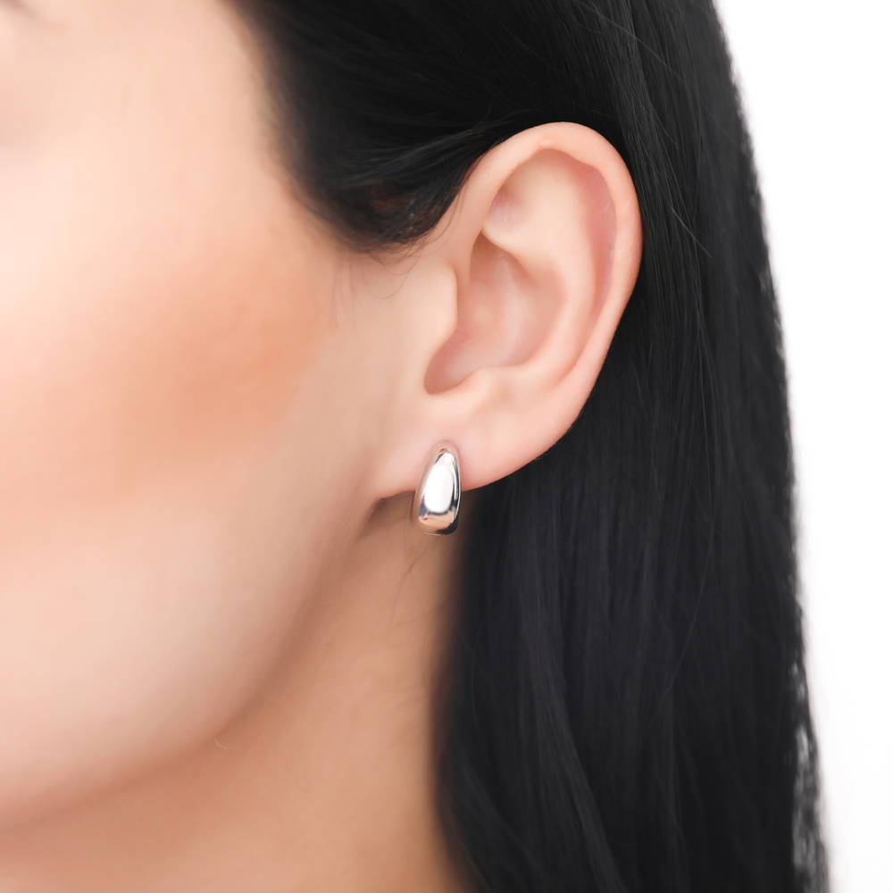 Model wearing Dome CZ Small Huggie Earrings in Sterling Silver 0.6 inch, Rhodium Plated