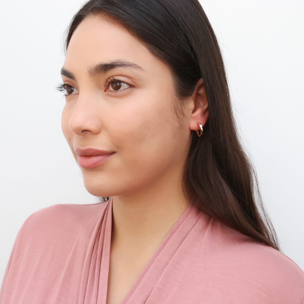 Model wearing Solitaire CZ Small Hoop Earrings in Sterling Silver 0.6 inch, Yellow Gold Flashed