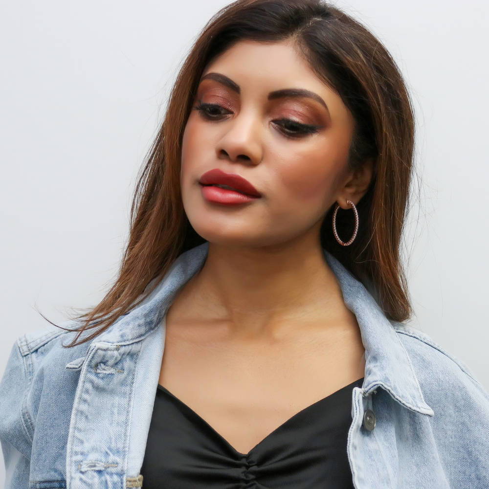 Model wearing Oval CZ Inside-Out Hoop Earrings in Sterling Silver 1.4 inch, Rhodium Plated