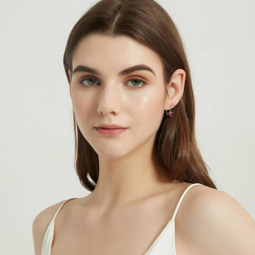 Model wearing Solitaire Heart Heart CZ Leverback Earrings in Sterling Silver, Red Color