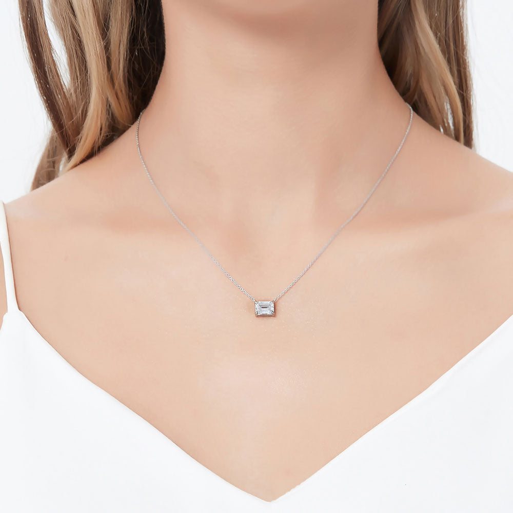 Model wearing Solitaire East-West Emerald Cut CZ Necklace in Sterling Silver, Rhodium Plated