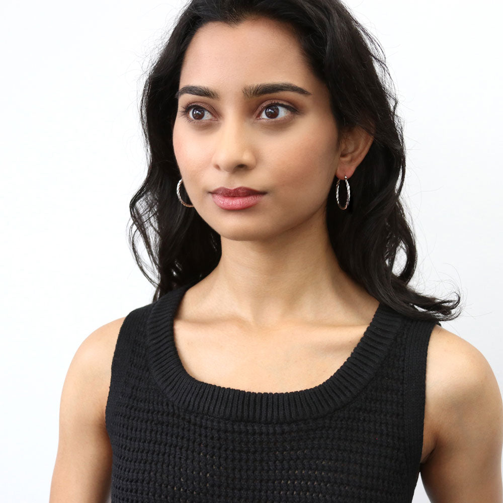 Model wearing Cable Hoop Earrings in Sterling Silver 1.2 inch, Yellow Gold Flashed