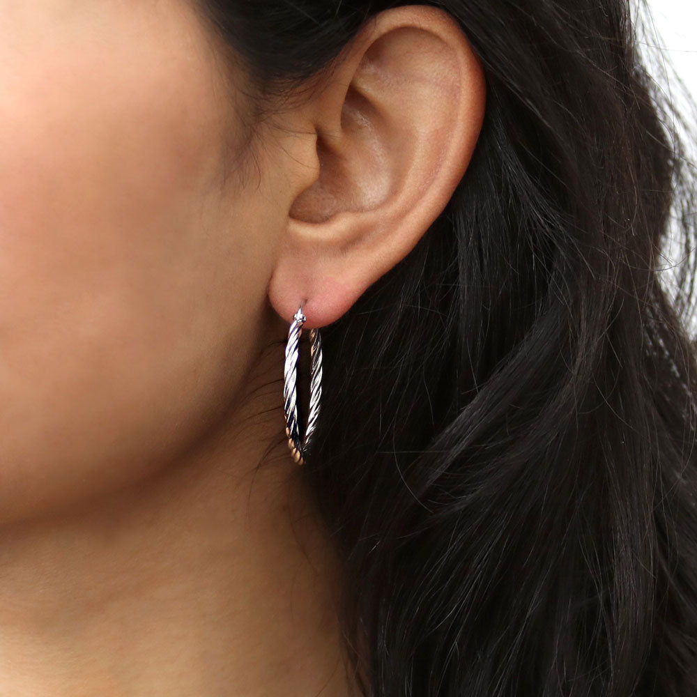 Model wearing Cable Hoop Earrings in Sterling Silver 1.2 inch, Yellow Gold Flashed