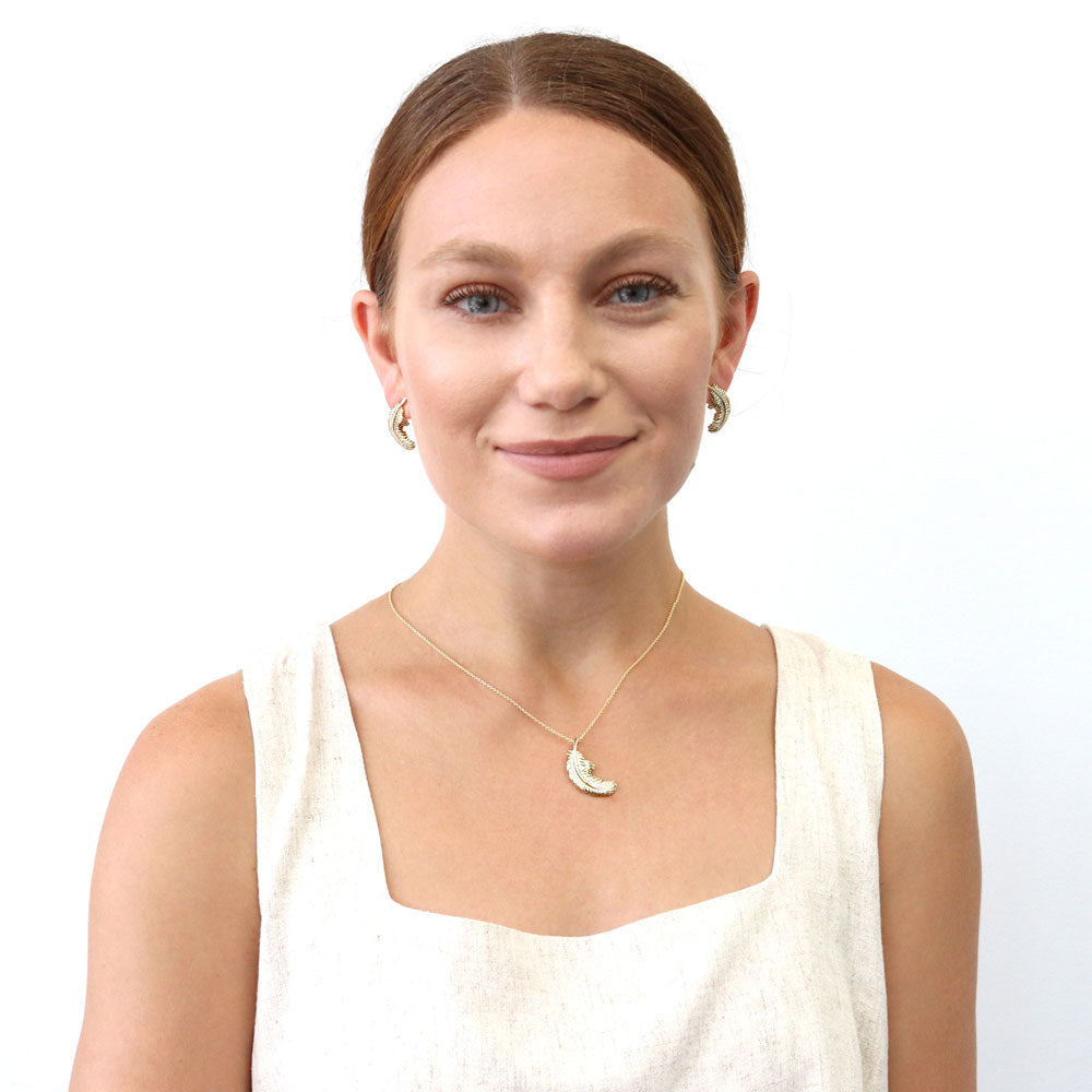 Model wearing Feather CZ Stud Earrings in Sterling Silver, Yellow Gold Flashed