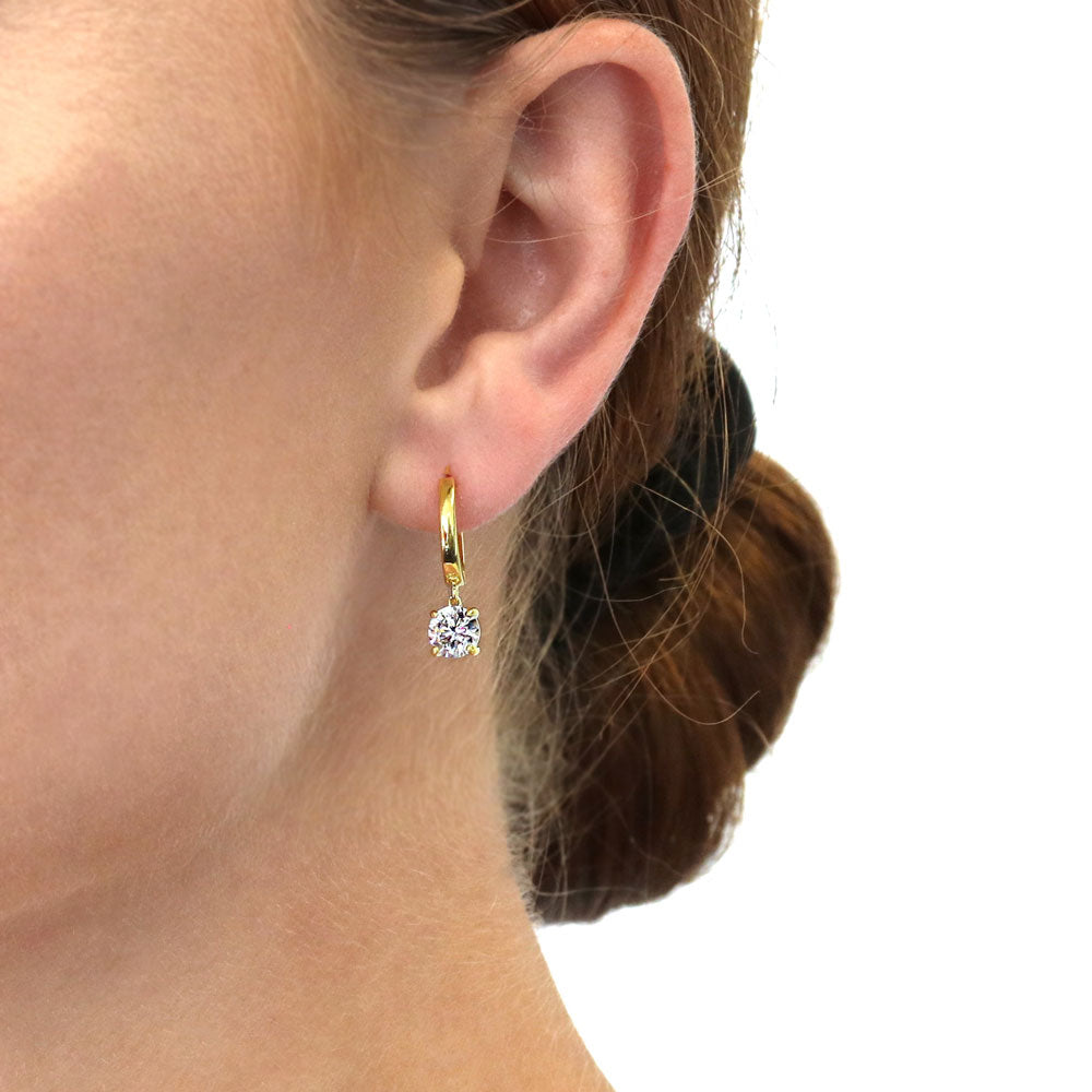 Model wearing Solitaire CZ Cartilage Huggie Earrings in Sterling Silver 0.5 inch, Yellow Gold Flashed / Round Cut