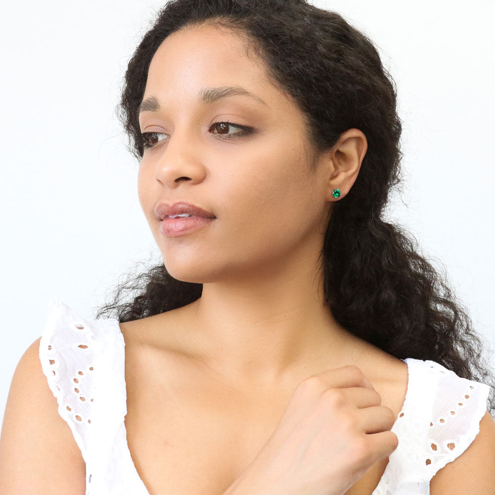 Model wearing Solitaire 1.6ct CZ Cartilage Stud Earrings in Sterling Silver, Emerald Color