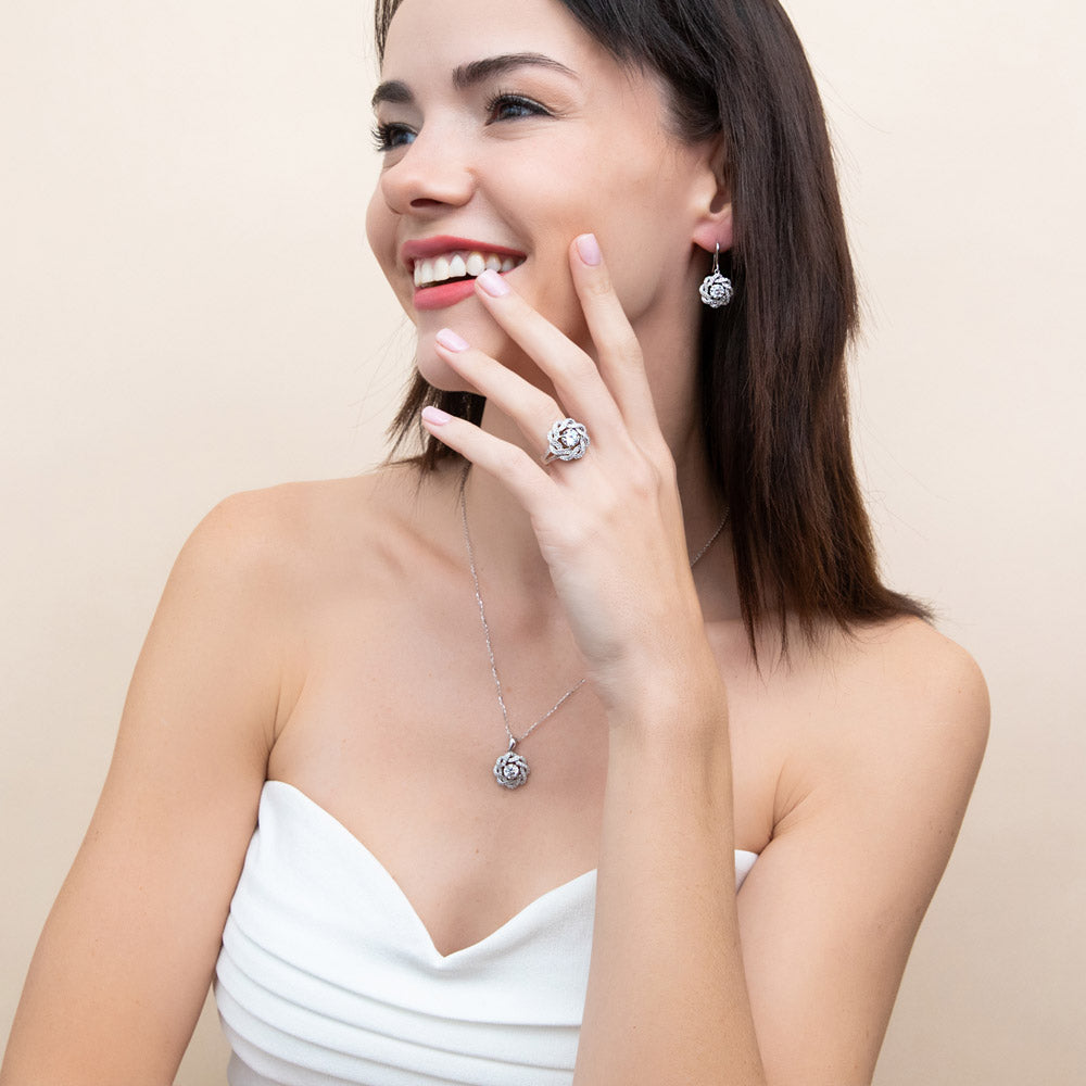 Model wearing Flower Ribbon CZ Necklace and Earrings Set in Sterling Silver, 3 of 11