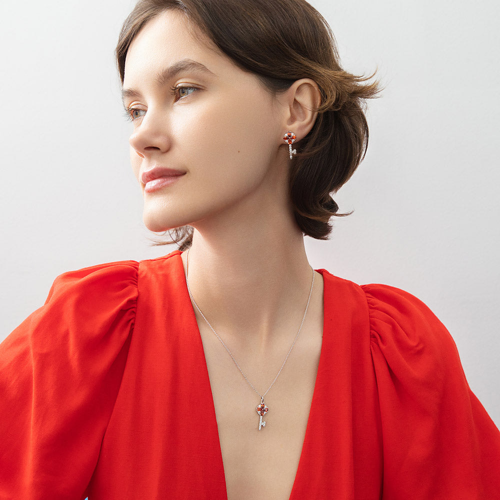 Model wearing Key and Lock CZ Stud Earrings in Sterling Silver, Red Color