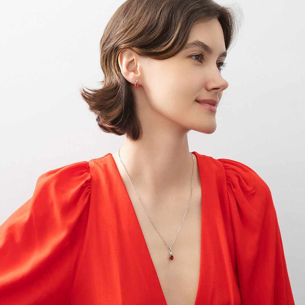 Model wearing Solitaire 2-Stone 1.4ct Pear CZ Stud Earrings in Sterling Silver, Garnet Color