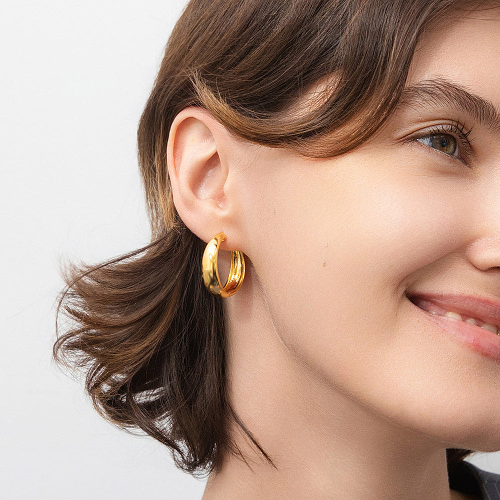 Model wearing Dome Small Hoop Earrings in Sterling Silver 1 inch, Yellow Gold Flashed