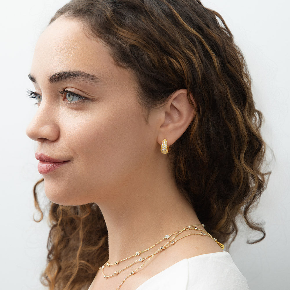 Model wearing Dome CZ Small Huggie Earrings in Sterling Silver 0.6 inch, Yellow Gold Flashed, Cubic Zirconia