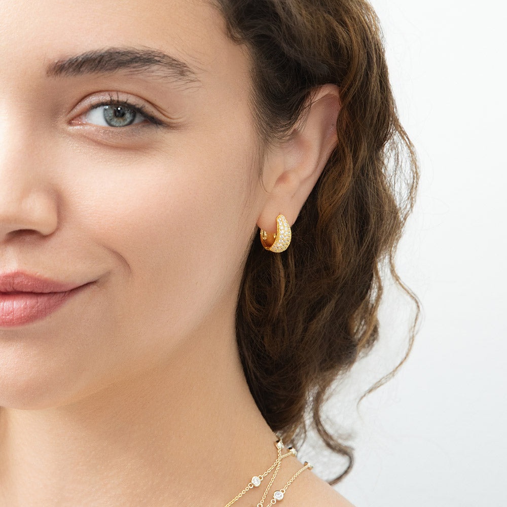 Model wearing Dome CZ Small Huggie Earrings in Sterling Silver 0.6 inch, Yellow Gold Flashed, Cubic Zirconia