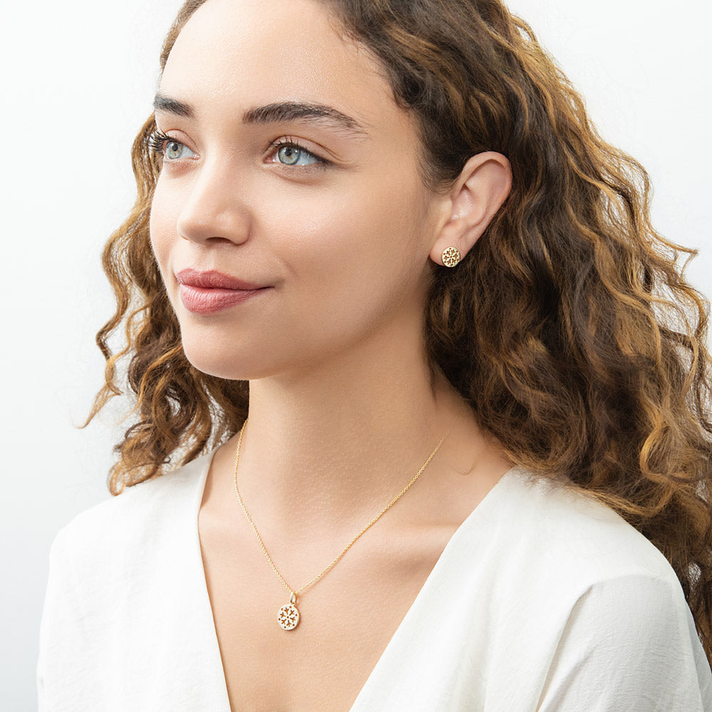 Model wearing Snowflake Coin Stud Earrings in Sterling Silver, Yellow Gold Flashed
