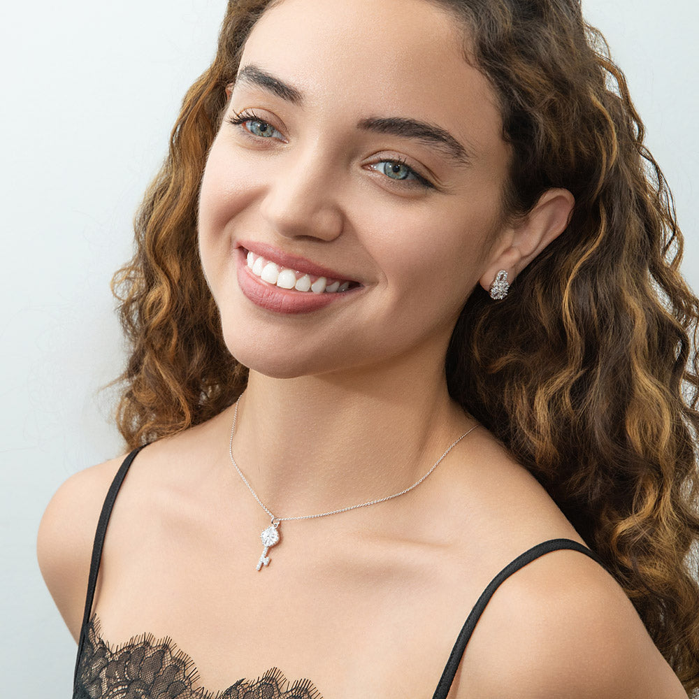 Model wearing Key and Lock CZ Stud Earrings in Sterling Silver, Clear Color