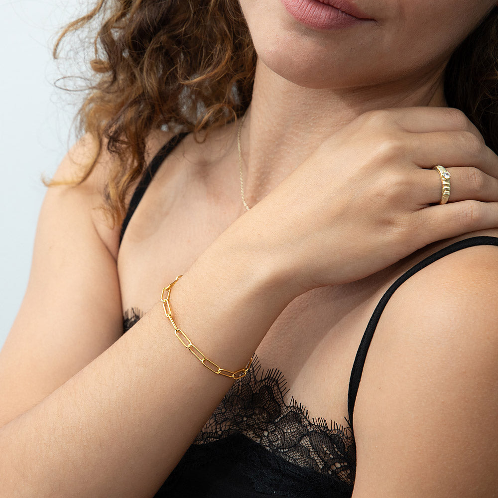 Model wearing Paperclip Link Chain Bracelet in Sterling Silver 4mm, Yellow Gold Flashed