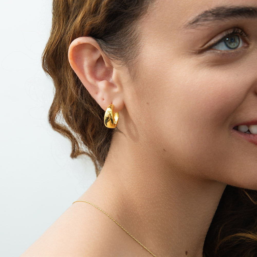 Model wearing Dome Small Hoop Earrings in Sterling Silver 0.8 inch, Yellow Gold Flashed