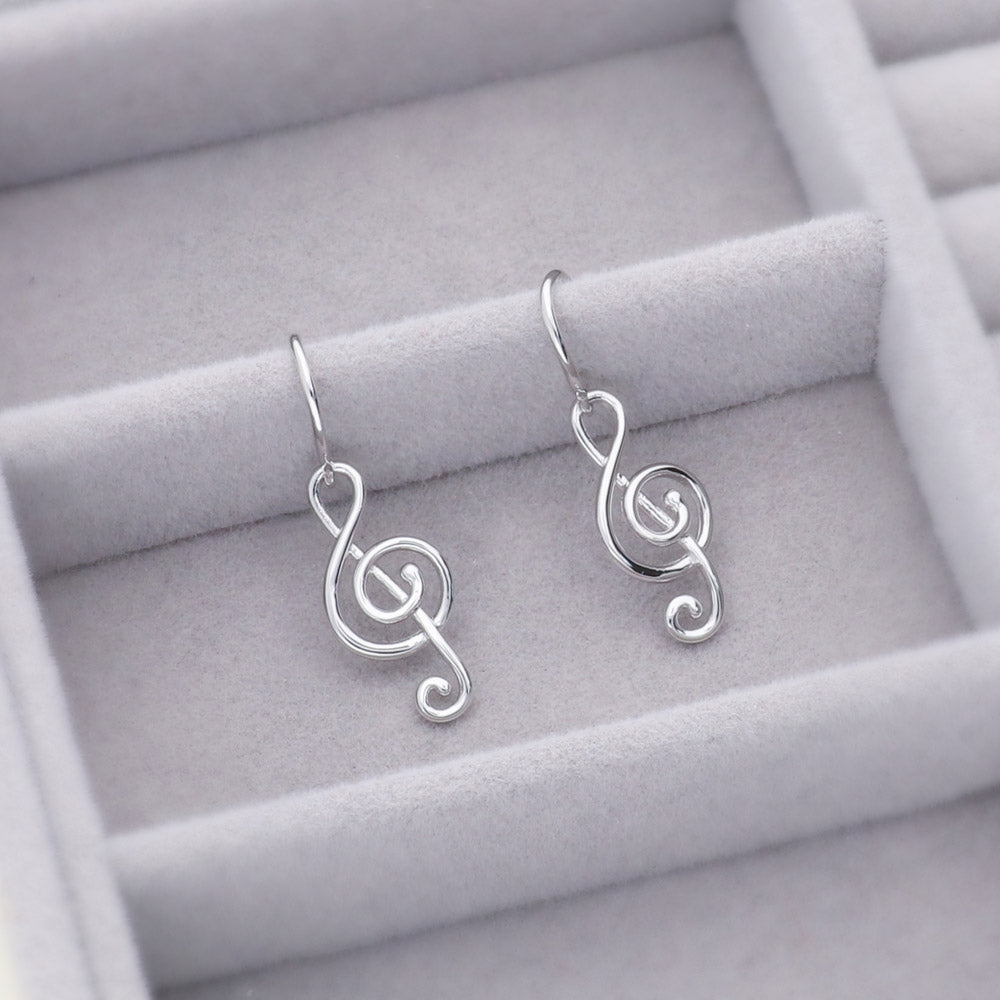 Flatlay view of Treble Clef Music Note Necklace and Earrings Set in Sterling Silver, 11 of 13