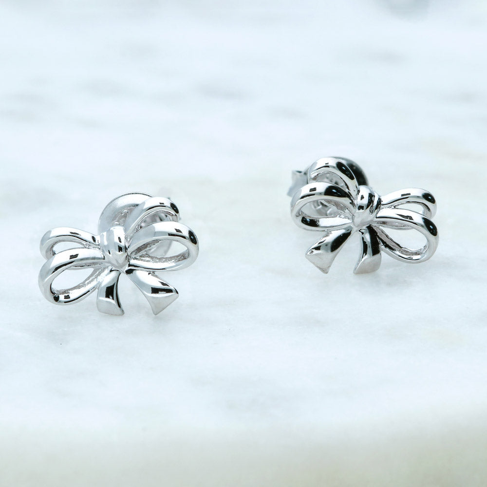 Flatlay view of Bow Tie Ribbon CZ Stud Earrings in Sterling Silver, Style 1