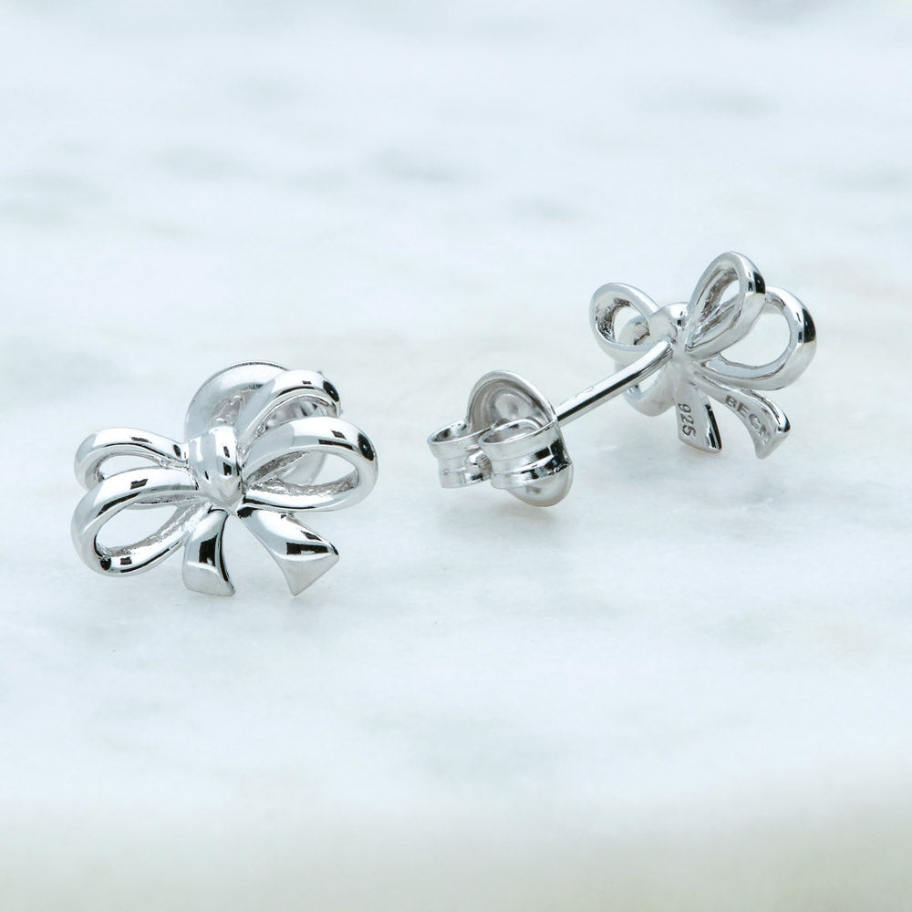 Flatlay view of Bow Tie Ribbon CZ Stud Earrings in Sterling Silver, Style 1