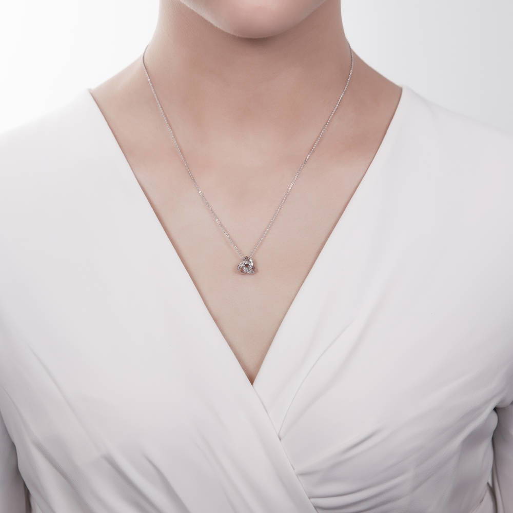 Model wearing Love Knot CZ Necklace and Earrings Set in Sterling Silver, 11 of 14
