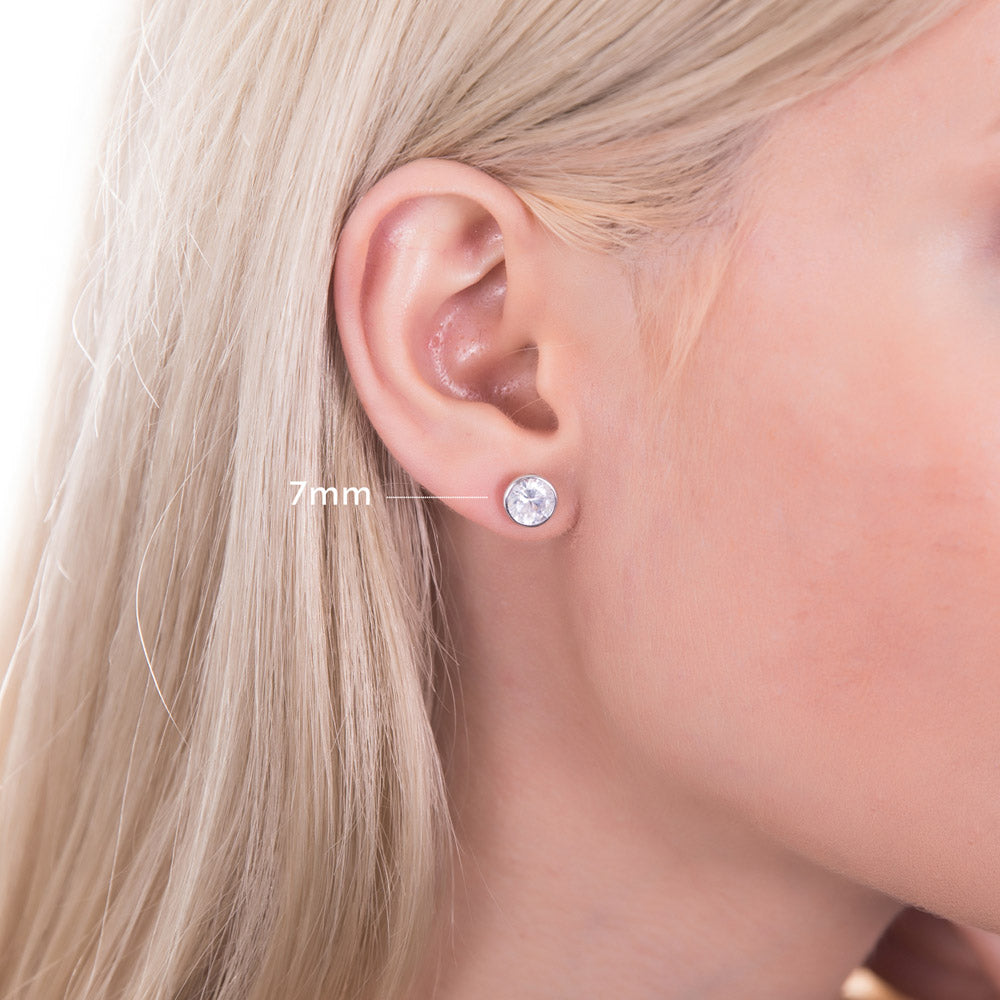 Model wearing Solitaire Bezel CZ Stud Earrings in Sterling Silver, 4mm