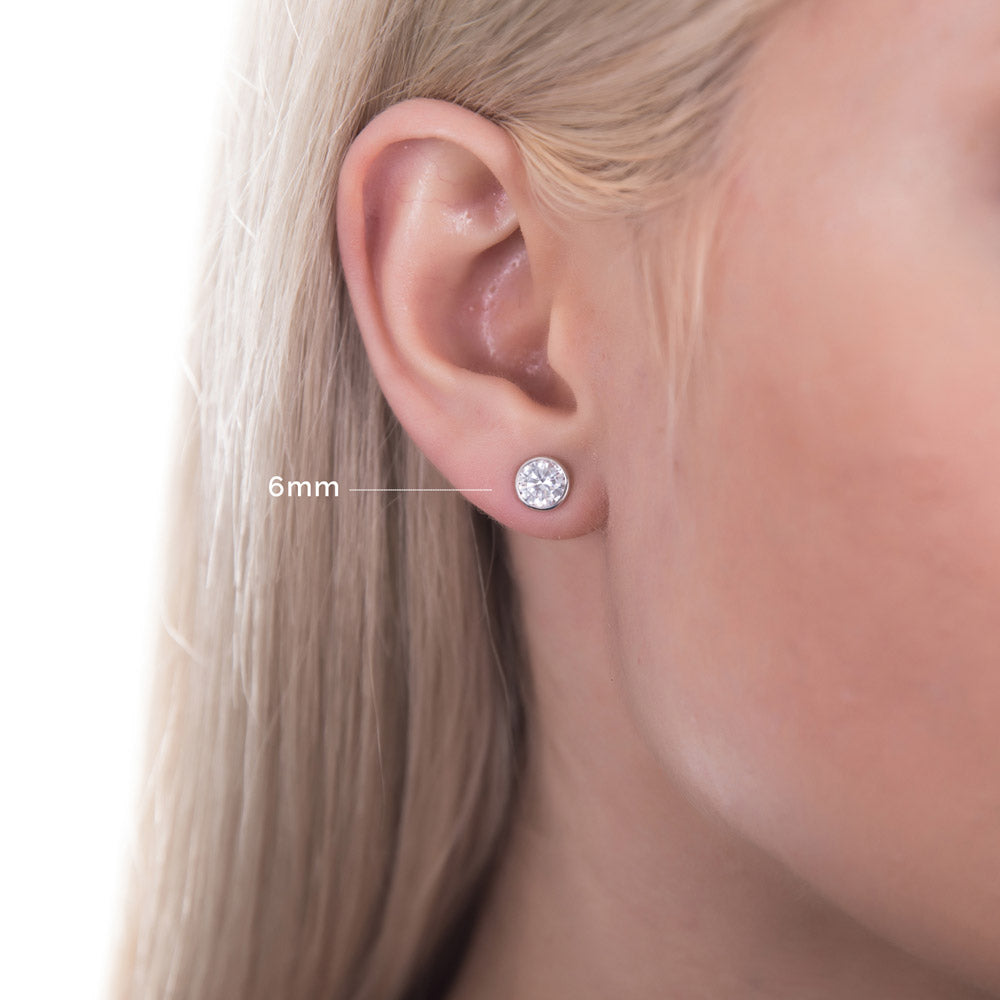 Model wearing Solitaire Bezel CZ Stud Earrings in Sterling Silver, 4mm