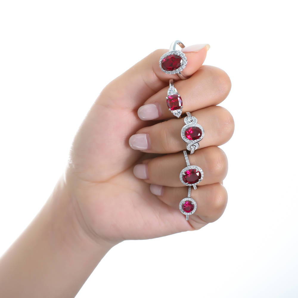 Model wearing 3-Stone Simulated Ruby Cushion CZ Ring in Sterling Silver, 9 of 9