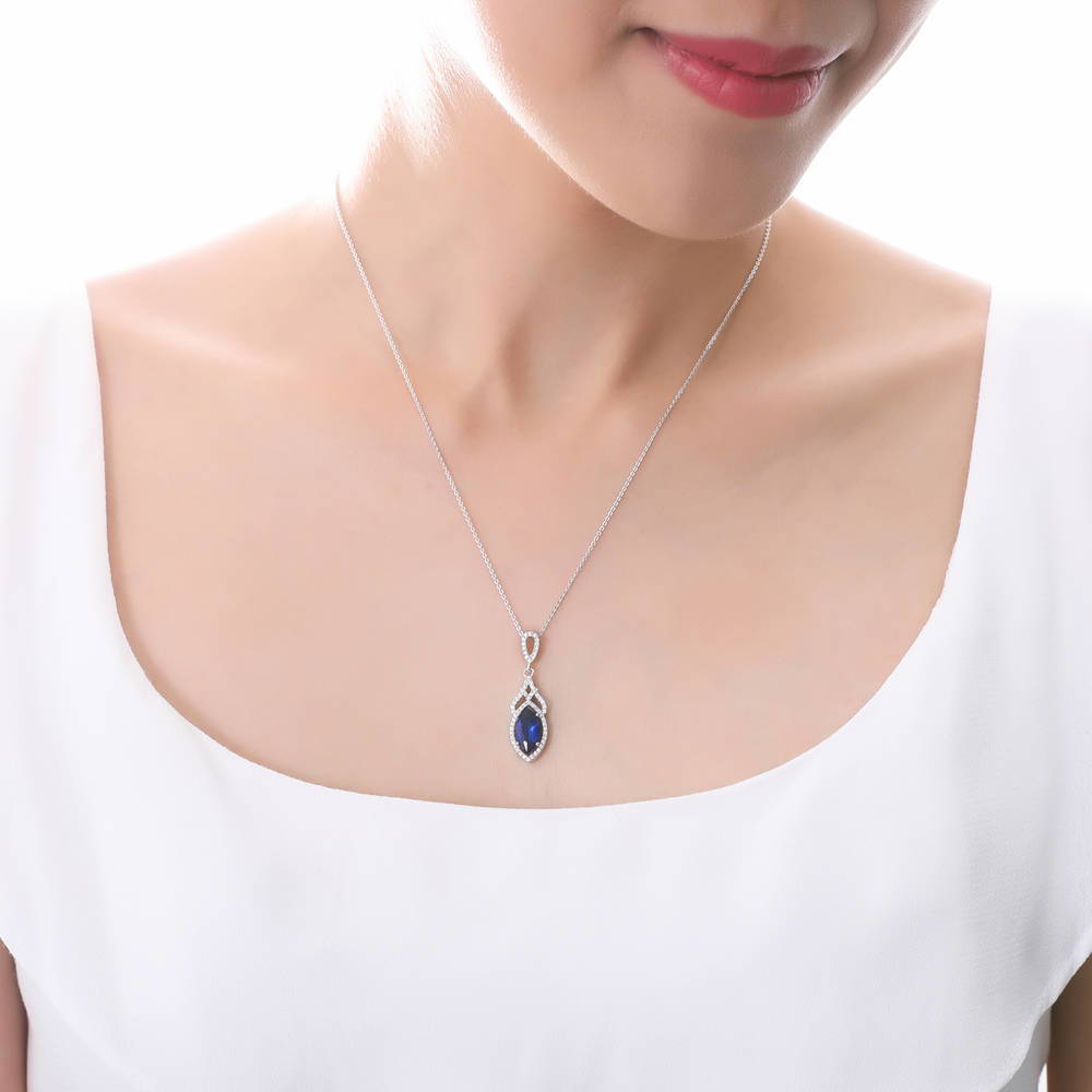 Model wearing Halo Simulated Blue Sapphire Marquise CZ Necklace in Sterling Silver, 2 of 5