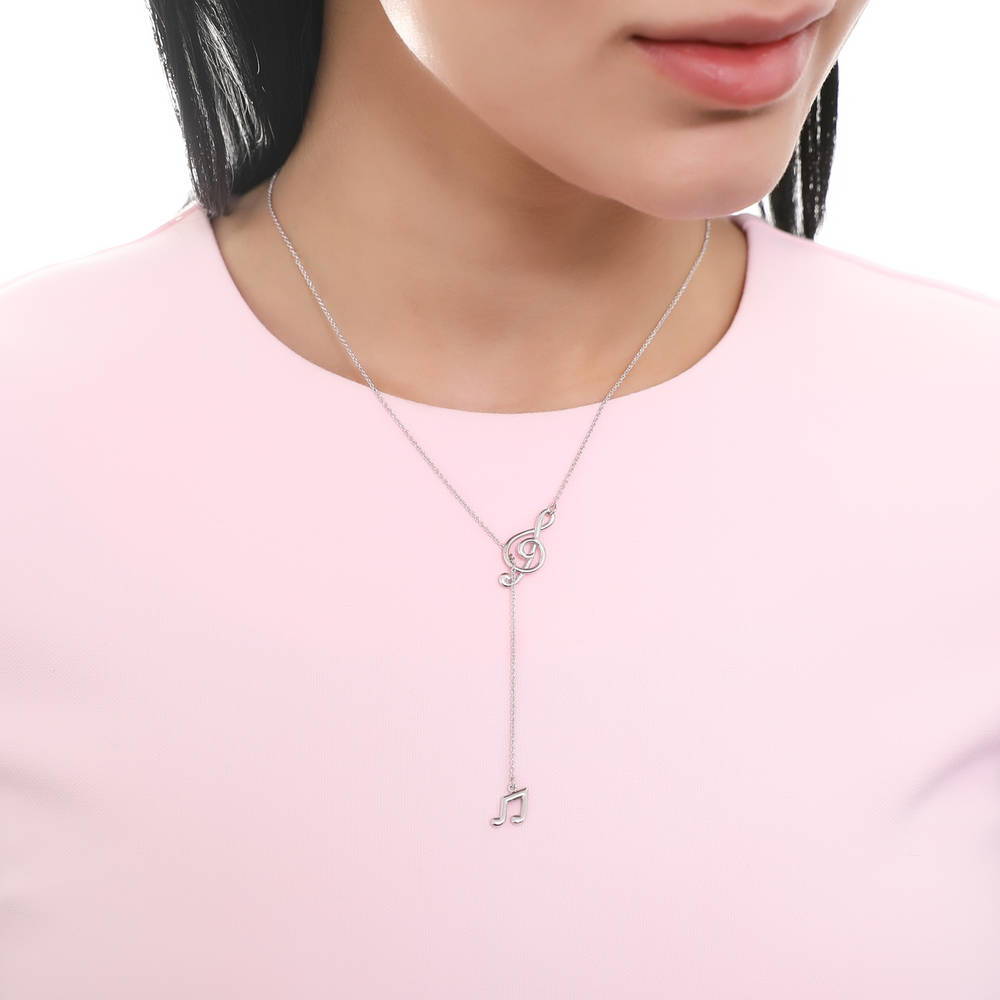 Model wearing Treble Clef Music Note Necklace and Earrings Set in Sterling Silver, 10 of 13