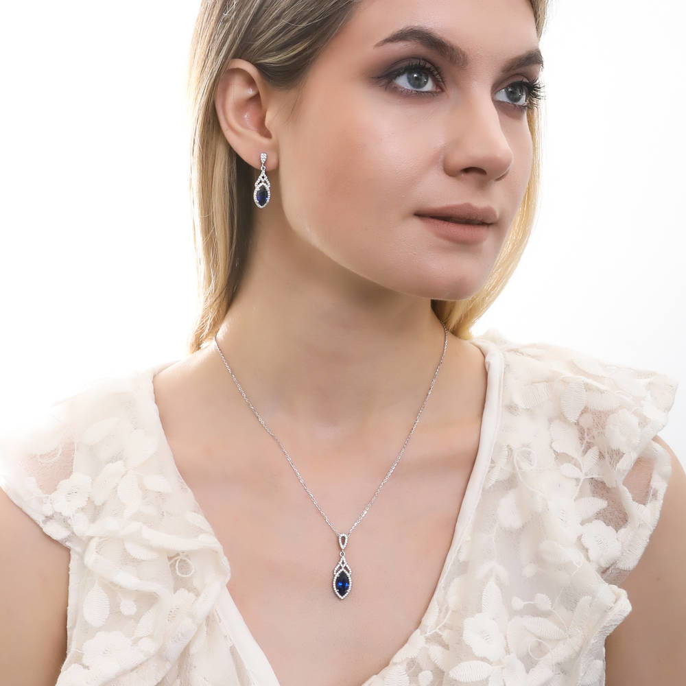 Model wearing Halo Simulated Blue Sapphire Marquise CZ Necklace in Sterling Silver, 3 of 5