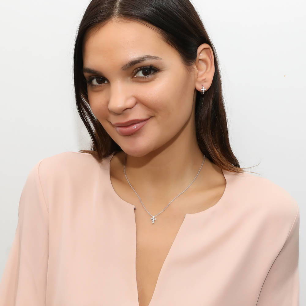 Model wearing Cross CZ Mini Huggie Earrings in Sterling Silver 0.5 inch, Yellow Gold Flashed