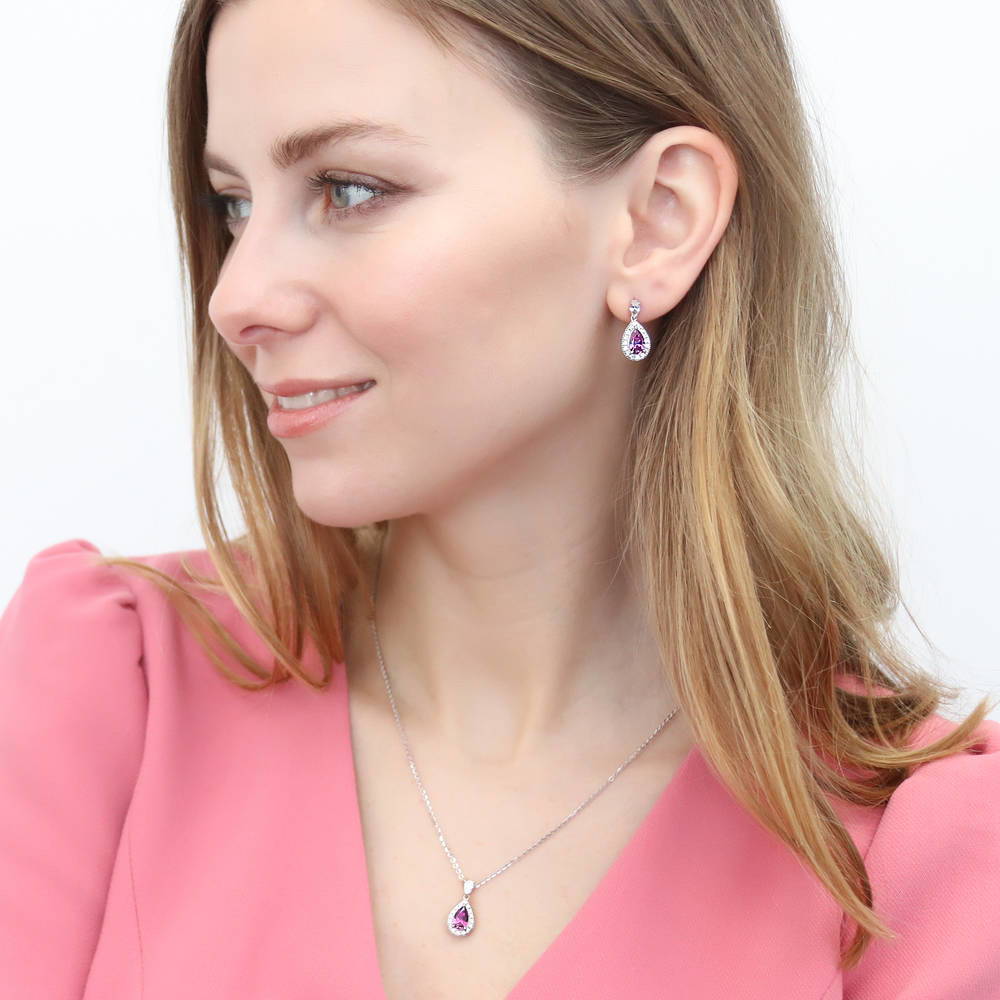 Model wearing Halo Pear CZ Earrings in Sterling Silver, Purple Color