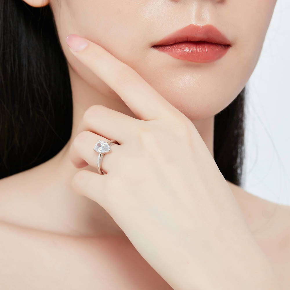 Model wearing Solitaire 1.8ct Pear CZ Ring Set in Sterling Silver, 9 of 14