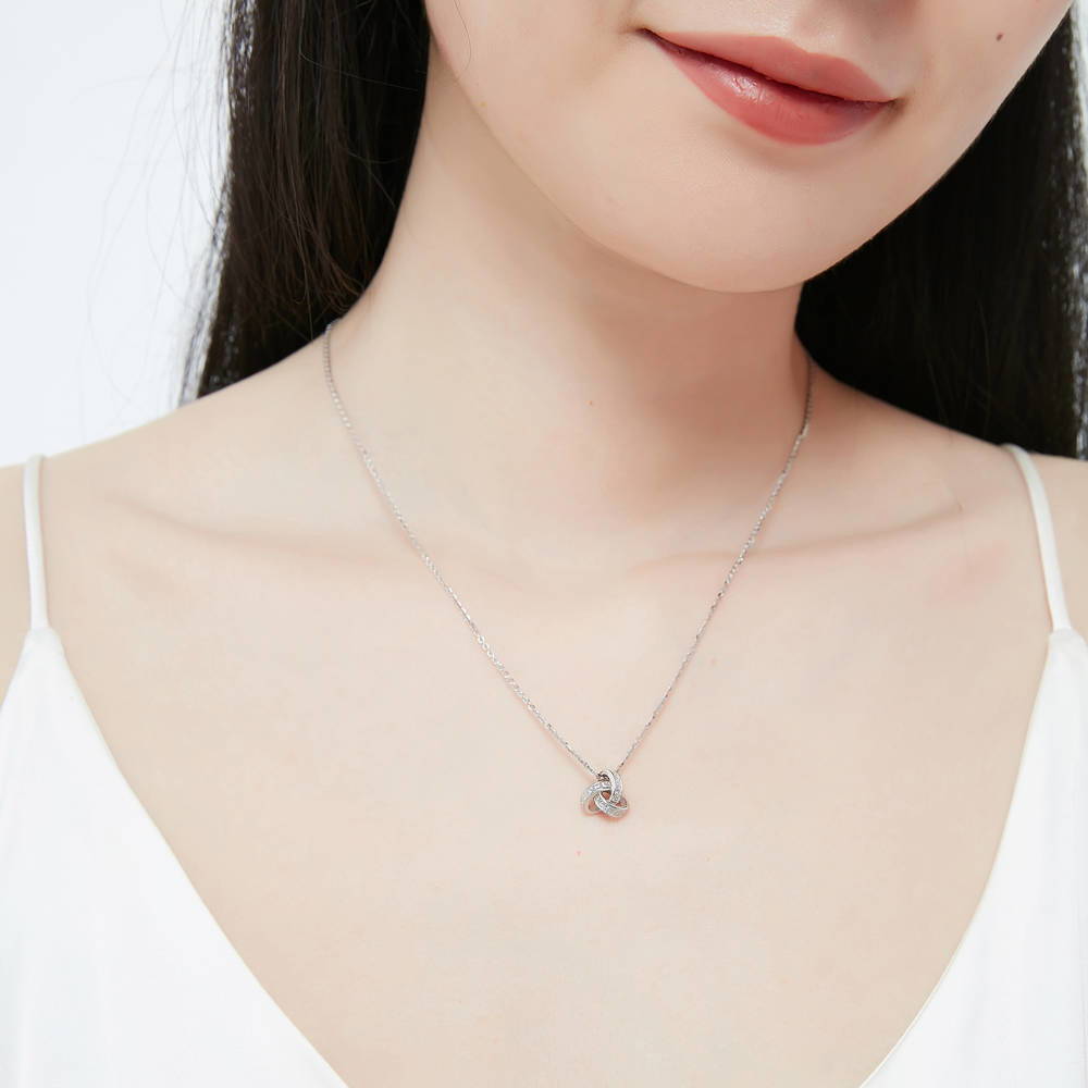 Model wearing Love Knot CZ Necklace and Earrings Set in Sterling Silver, 10 of 14