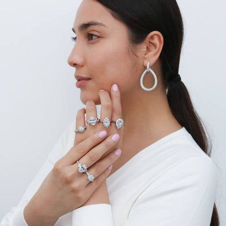 Model Wearing 3-Stone Ring, Halo Ring, Navette Ring, Teardrop Dangle Earrings