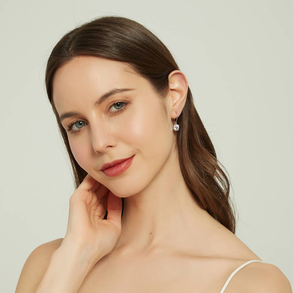 Model wearing Solitaire 4ct Round CZ Leverback Dangle Earrings in Sterling Silver, 5 of 5
