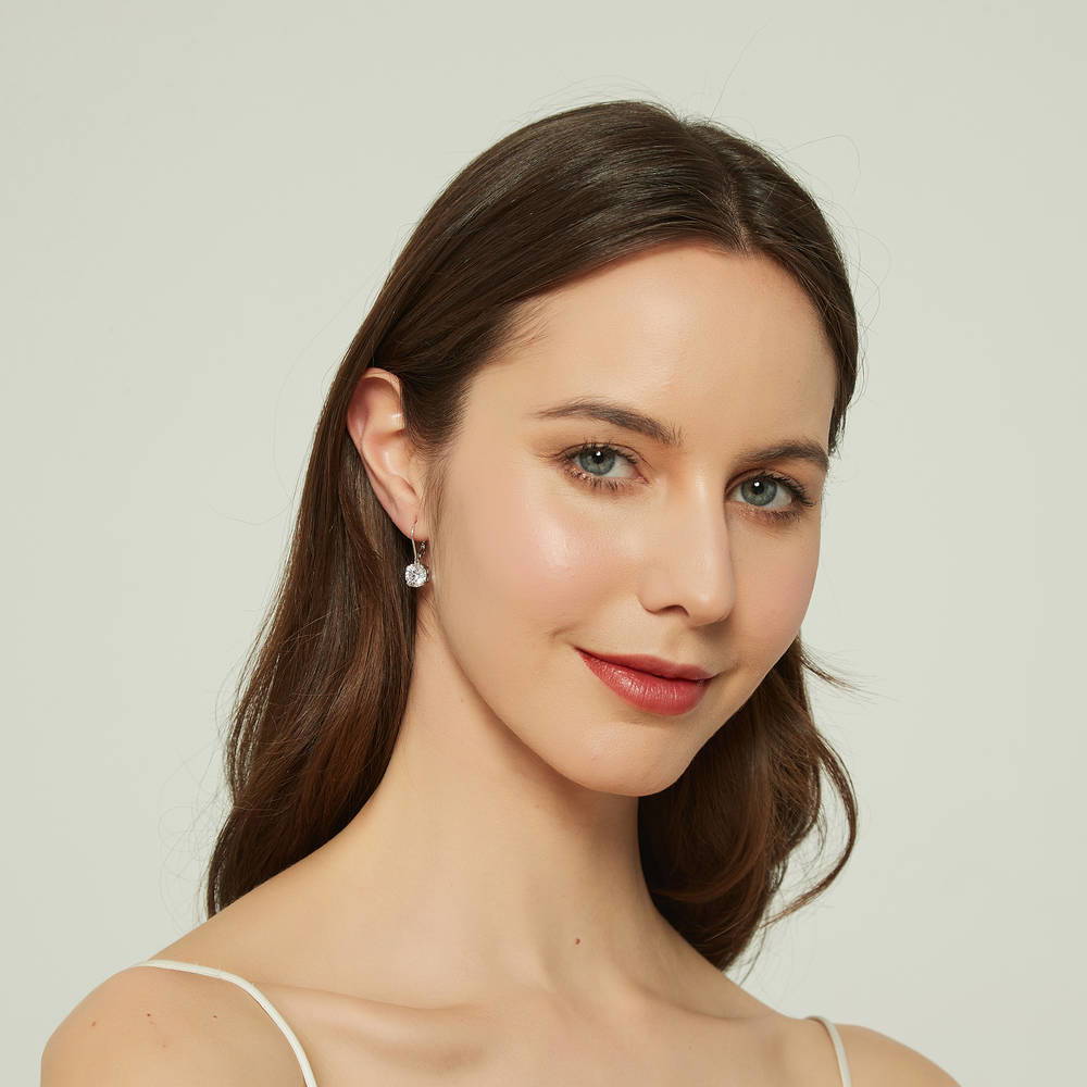 Model wearing Solitaire 4ct Round CZ Leverback Dangle Earrings in Sterling Silver, 4 of 5