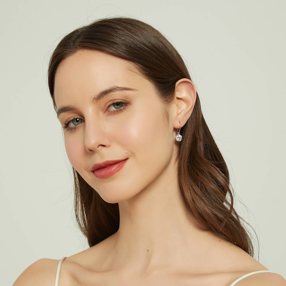 Model wearing Solitaire 4ct Round CZ Leverback Dangle Earrings in Sterling Silver, 3 of 5