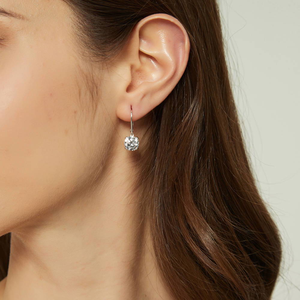 Model wearing Solitaire 4ct Round CZ Leverback Dangle Earrings in Sterling Silver, 2 of 5