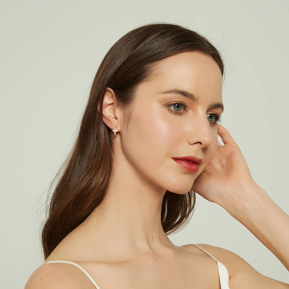 Model wearing Cross CZ Mini Huggie Earrings in Sterling Silver 0.5 inch, Yellow Gold Flashed
