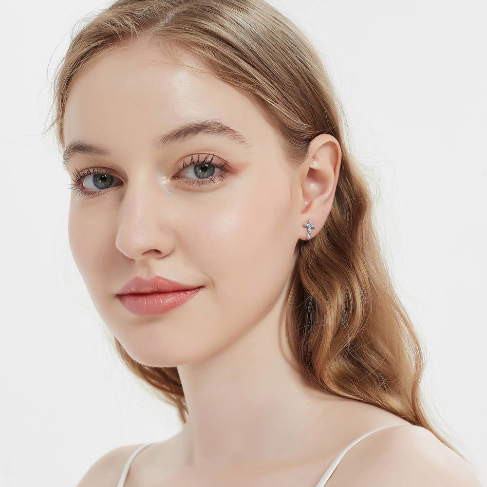 Model wearing Cross CZ Stud Earrings in Sterling Silver, Green Color