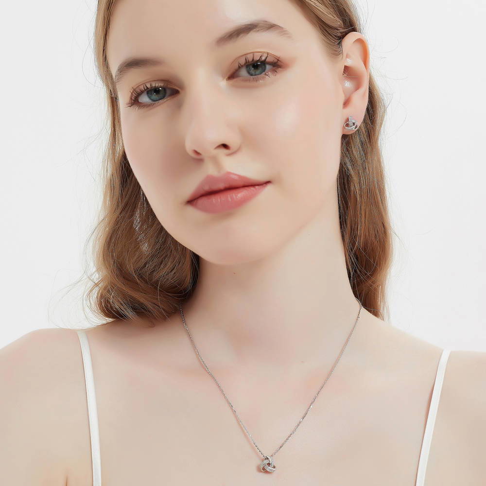 Model wearing Love Knot CZ Necklace and Earrings Set in Sterling Silver, 6 of 14