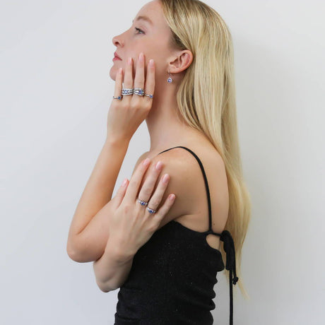 Model Wearing 3-Stone Ring, Curved Half Eternity Ring, Halo Dangle Earrings, Ring